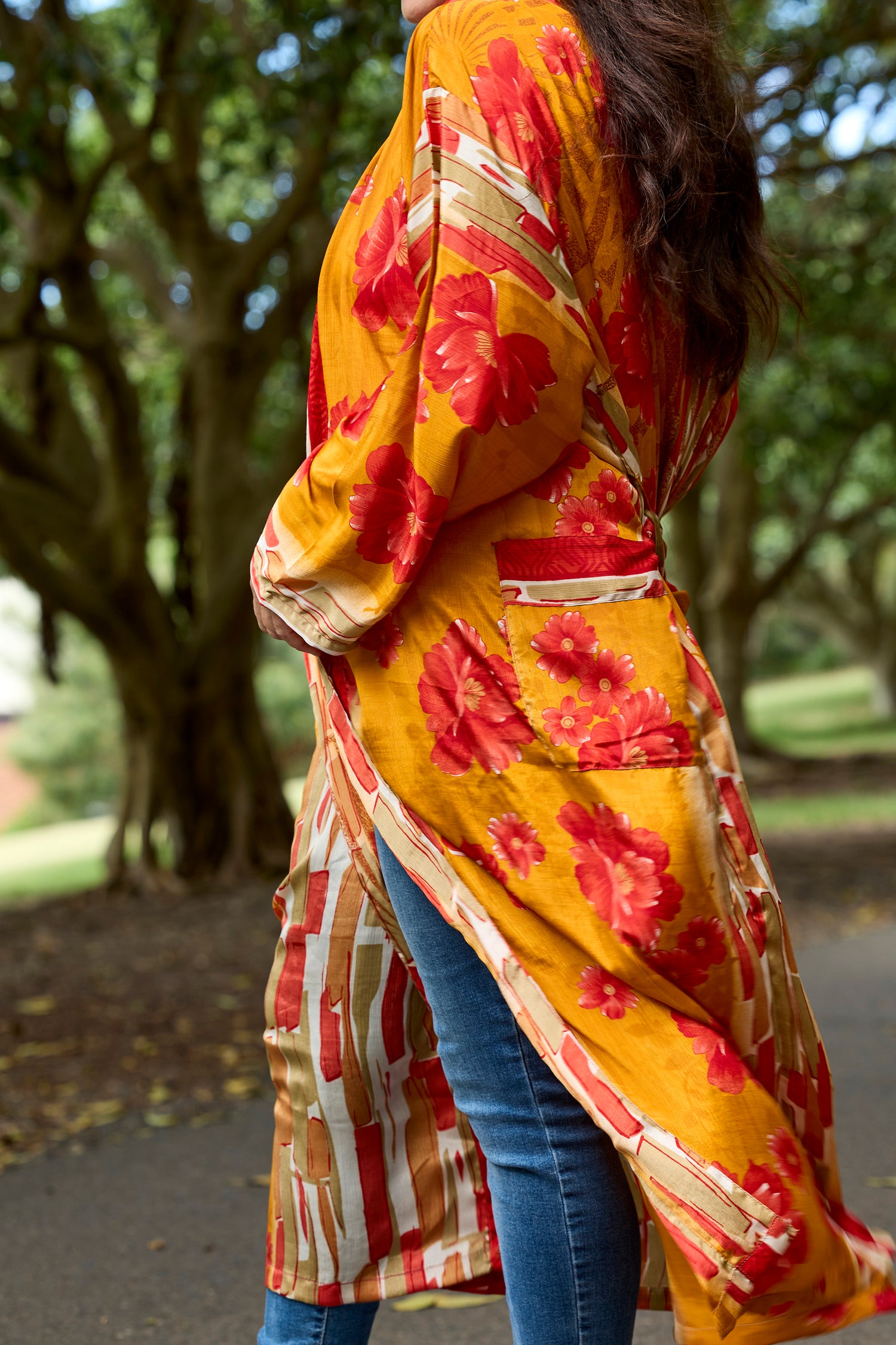 Woman wearing a boho floral printed upcycled sari gown