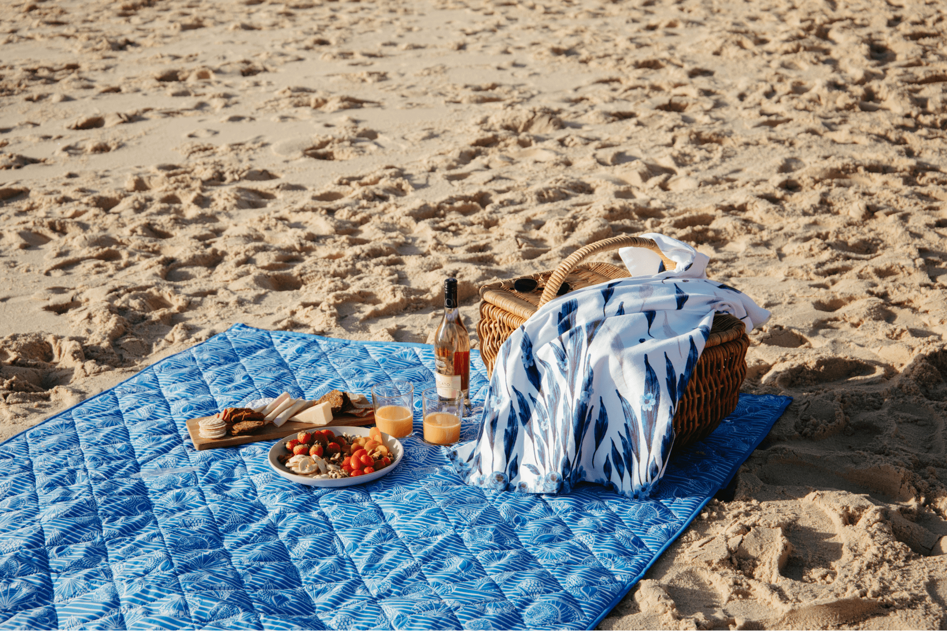 Breeze blue cover up dress draped over a picnic basket on the beach